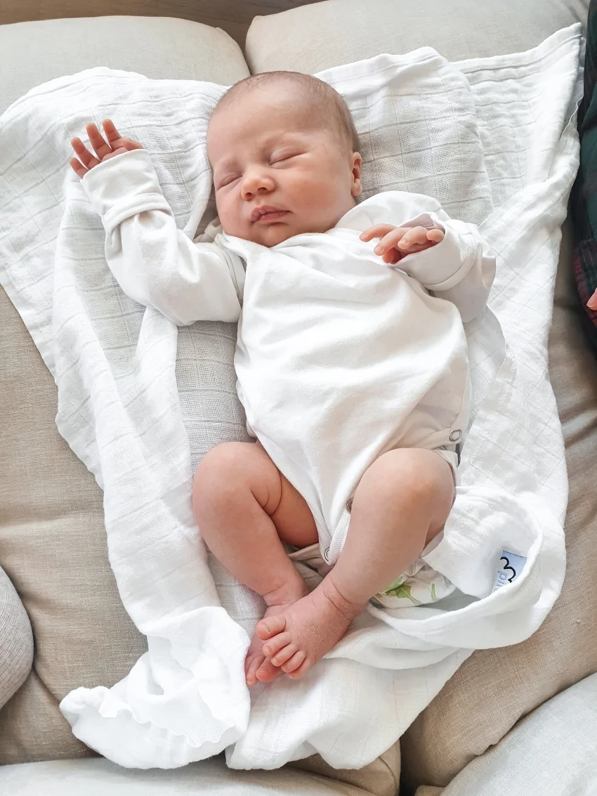 Newborn baby sleeping on a white blanket