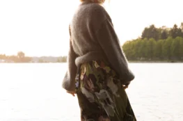 Charlotta standing in the sea wearing Kaiko's Olive Anemone Wrap Midi Dress